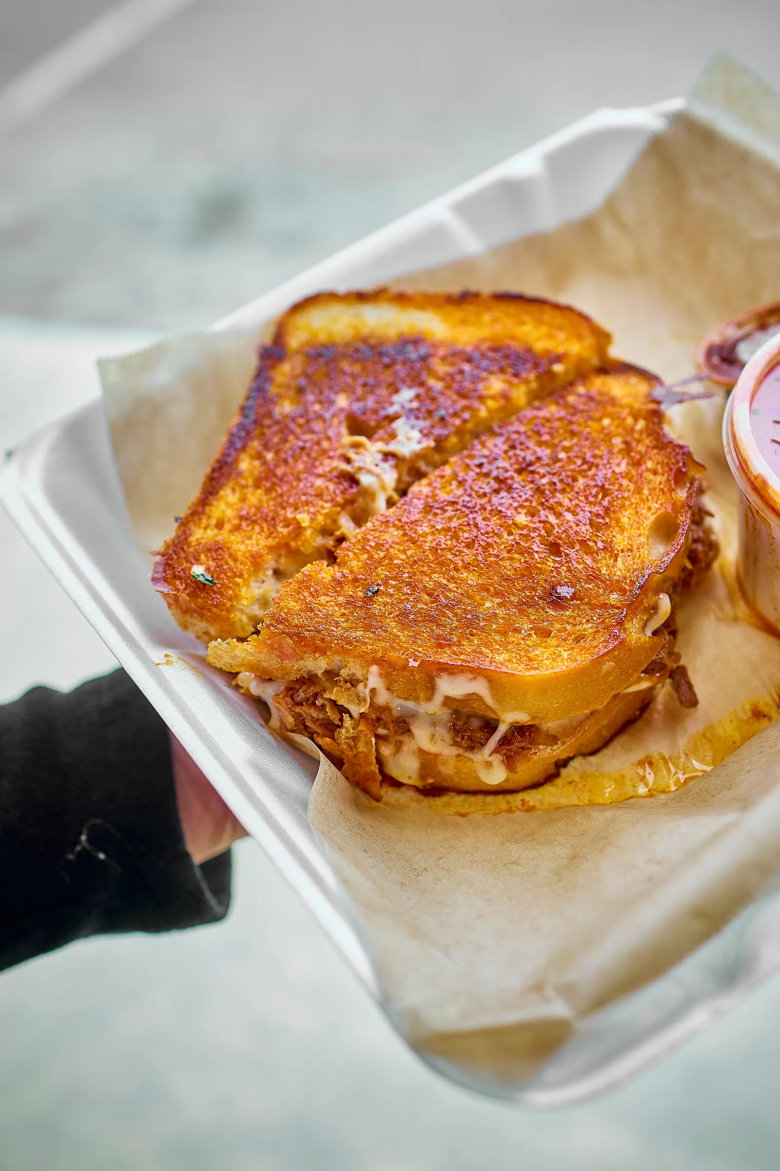 Birria grilled cheese with consommé at Mr. Birria